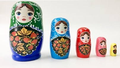 Custom Nesting Dolls Unique Collectibles A collection of colorful custom nesting dolls arranged from largest to smallest, showcasing a variety of themes and personalizations.